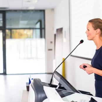 giving a presentation speech at podium